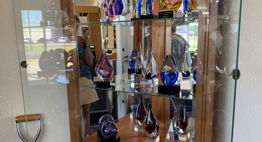 display case with glass trophies
