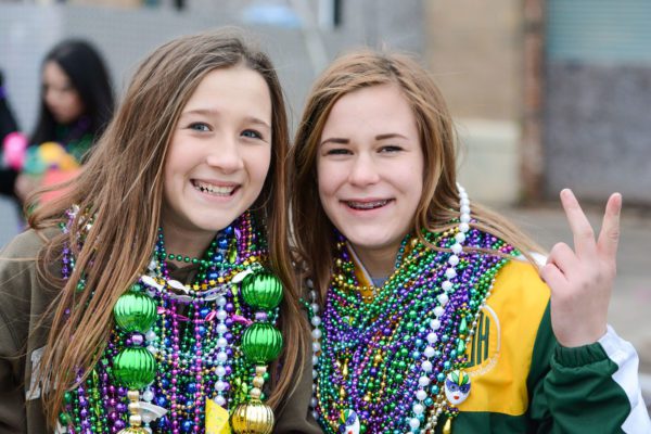 two girls wearing beads