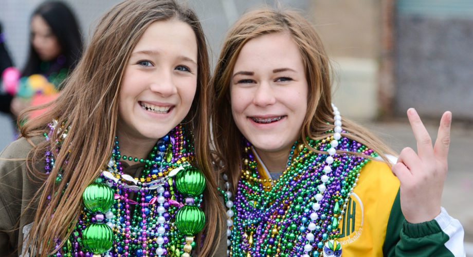 two girls wearing beads