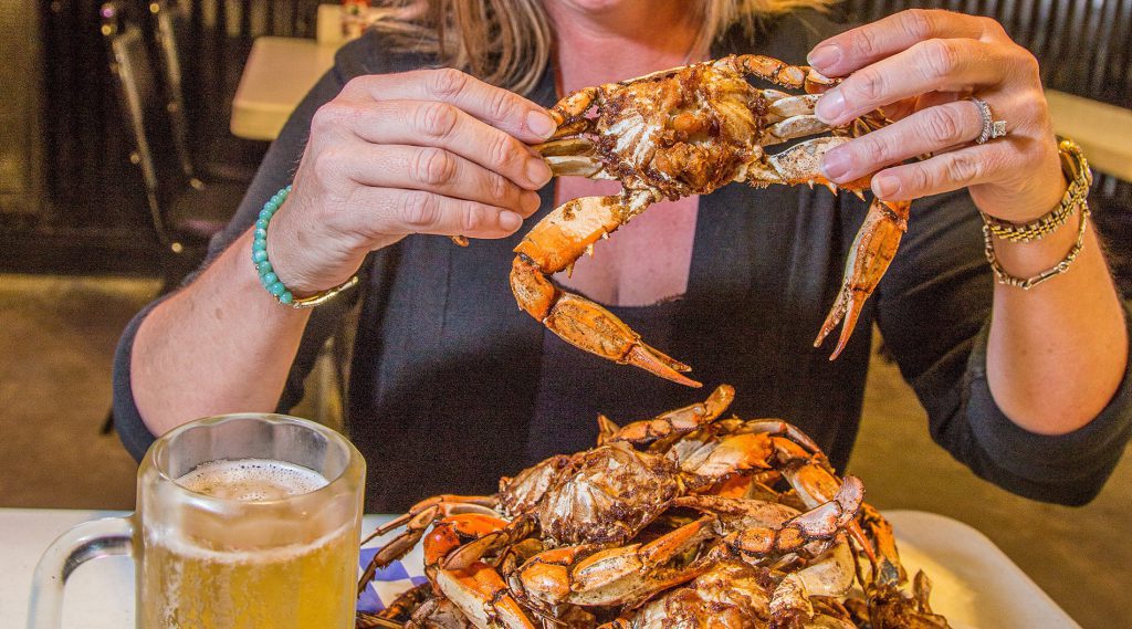 A plate full of crabs and a cold beer