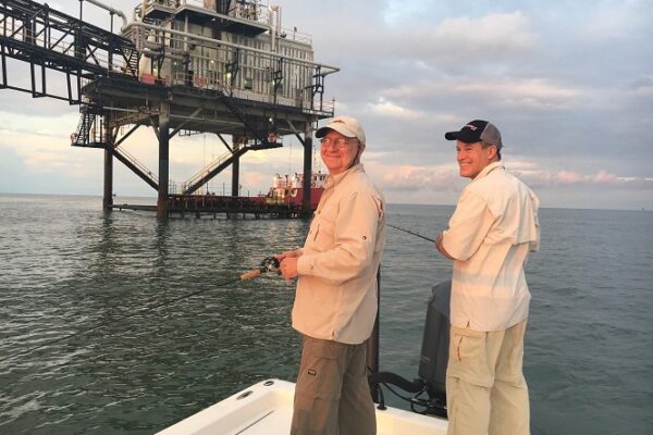 two men fishing near the rigs in port arthur texas