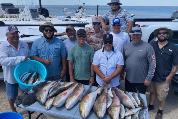 men showing off their fish catches on sabine lake in port arthur
