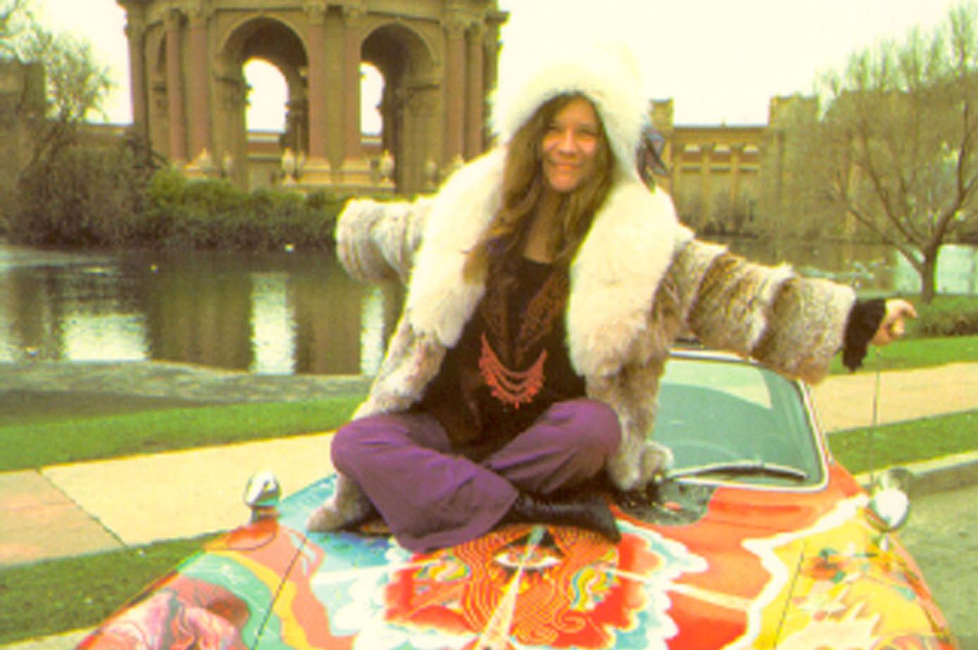 Janis sitting atop her famous painted porshe