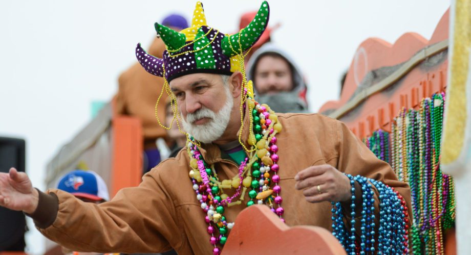 man riding float in parade