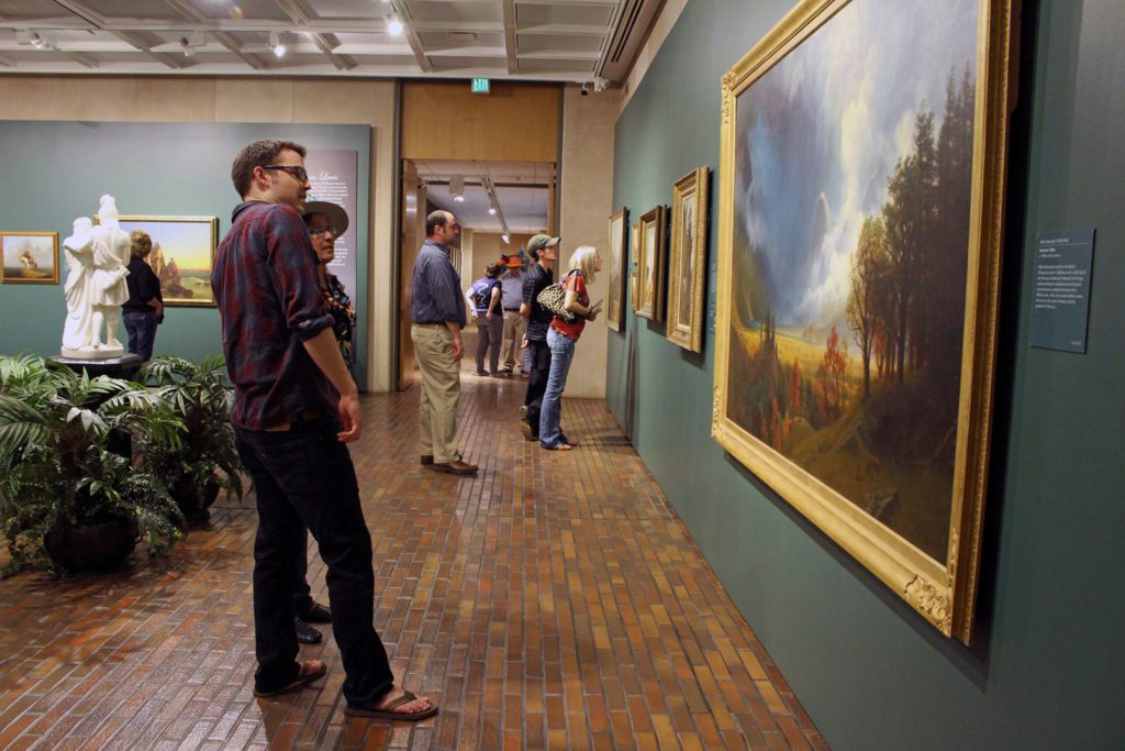 man looking at art in the stark museum of art in orange texas