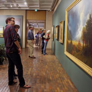 man looking at art in the stark museum of art in orange texas