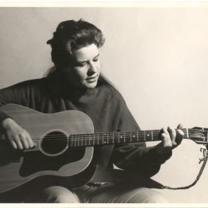 Janis Joplin playing the guitar