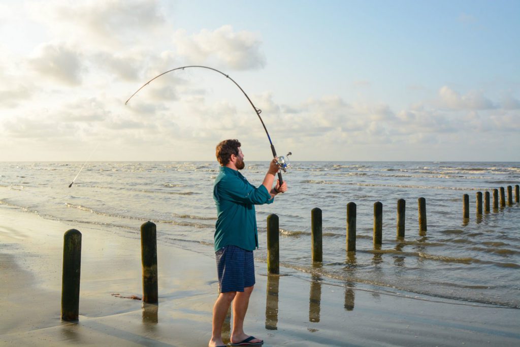 Man casting a line into the Gulf of Mexico