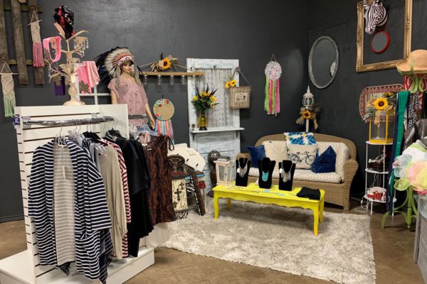 Boutique display with clothing and accessories against a dark wall