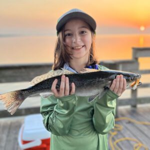 young girl showing off her catch on the pleasure island pier in port arthur texas