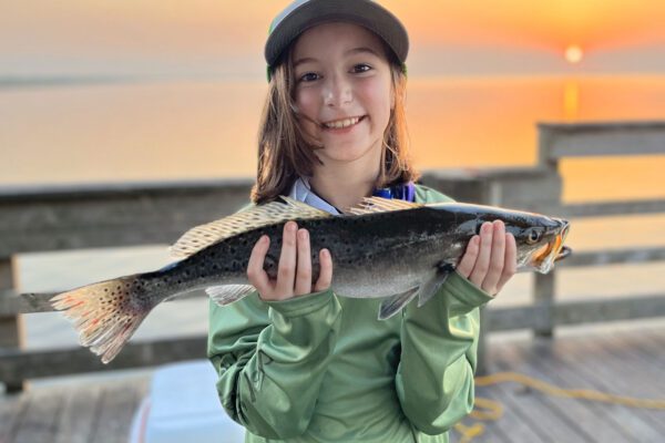 young girl showing off her catch on the pleasure island pier in port arthur texas