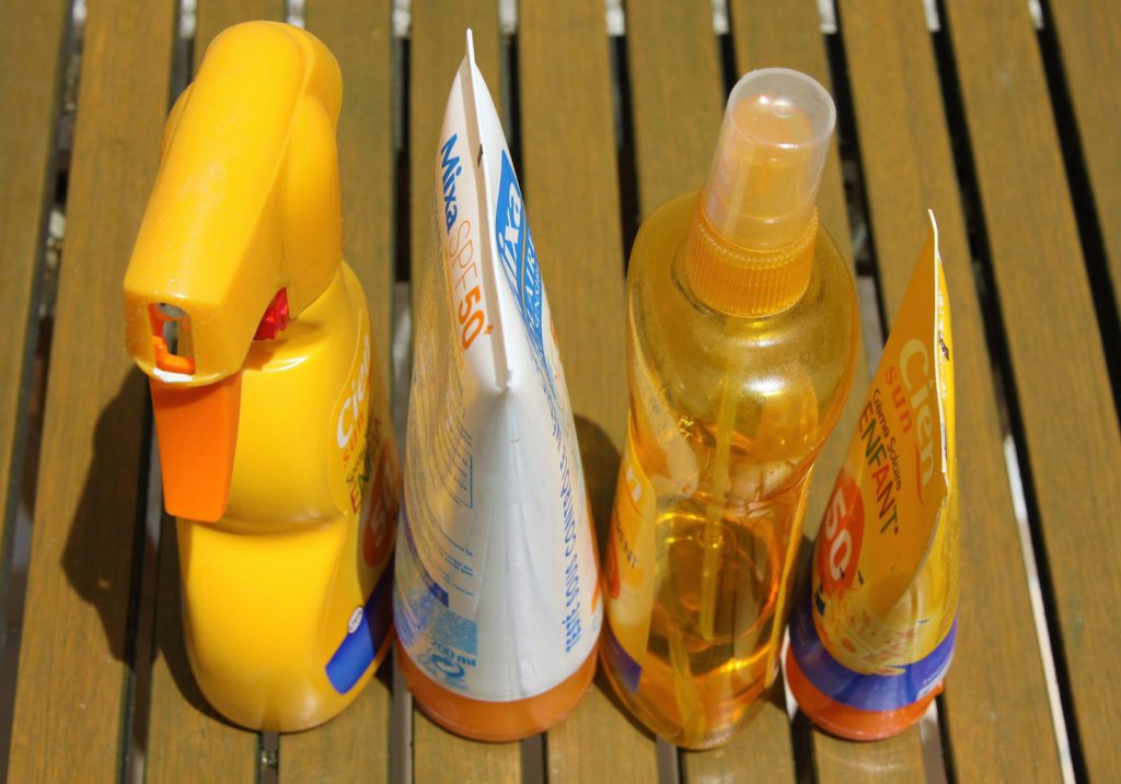 four bottles of various sunblocks 