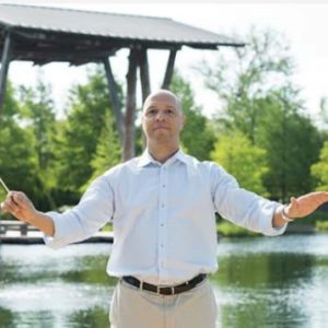 man standing in front of the lake