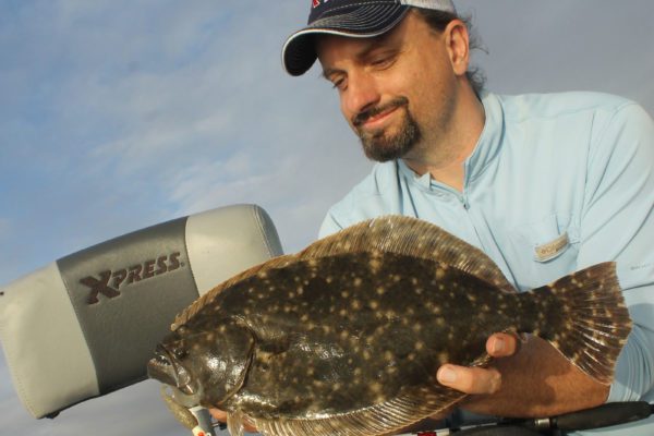 Chester Moore holding a flounder fish