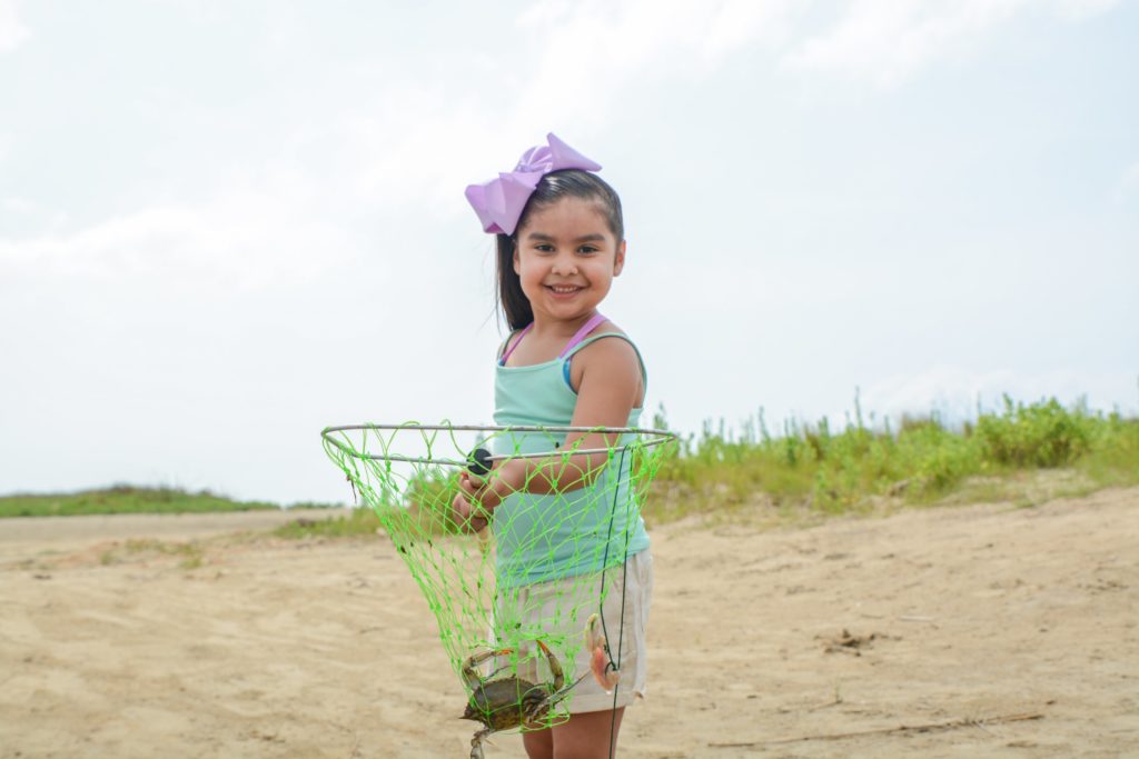 Little girl with crab and net