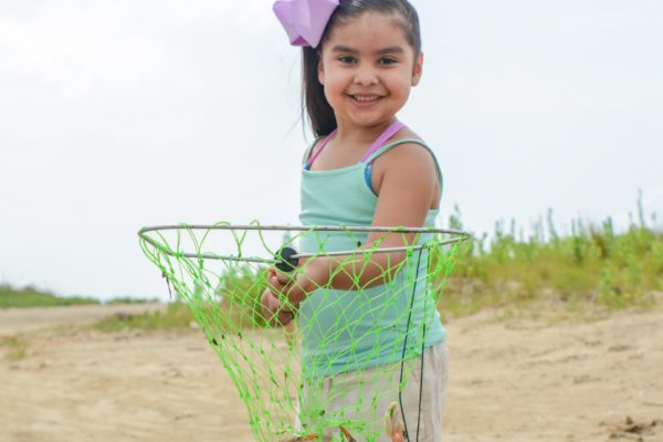 Little girl with crab and net