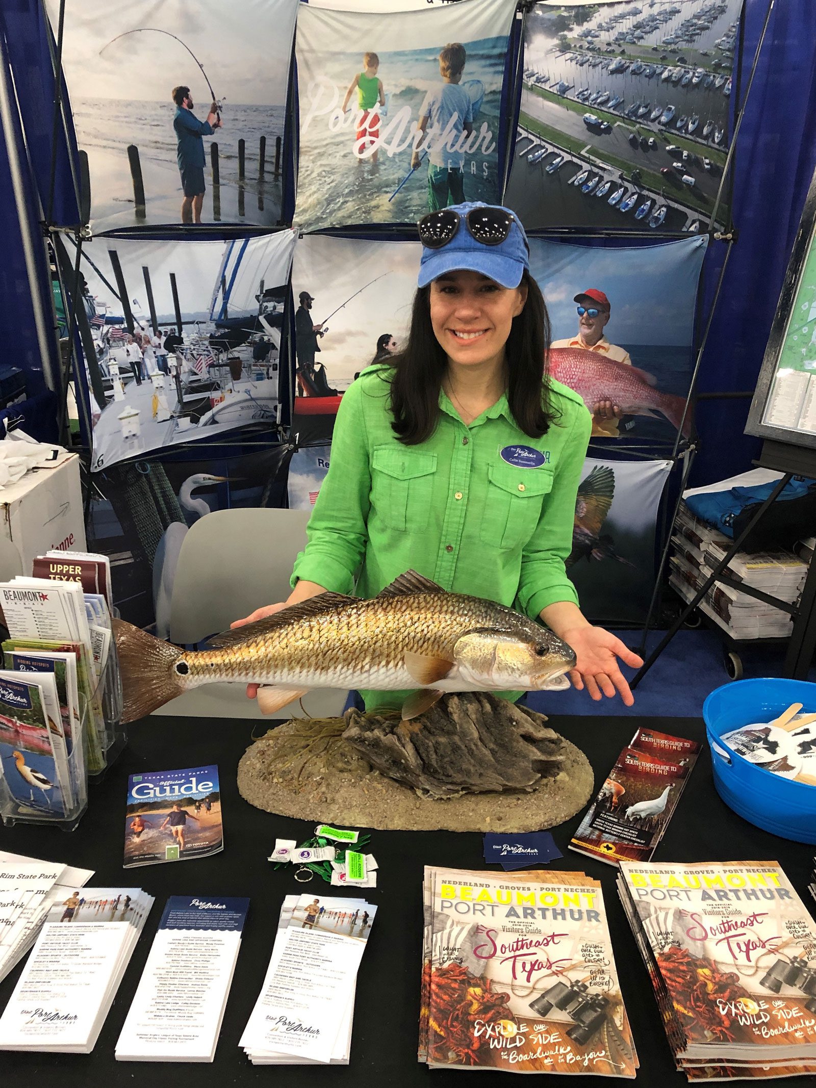 Girl standing behind a mounted redfish