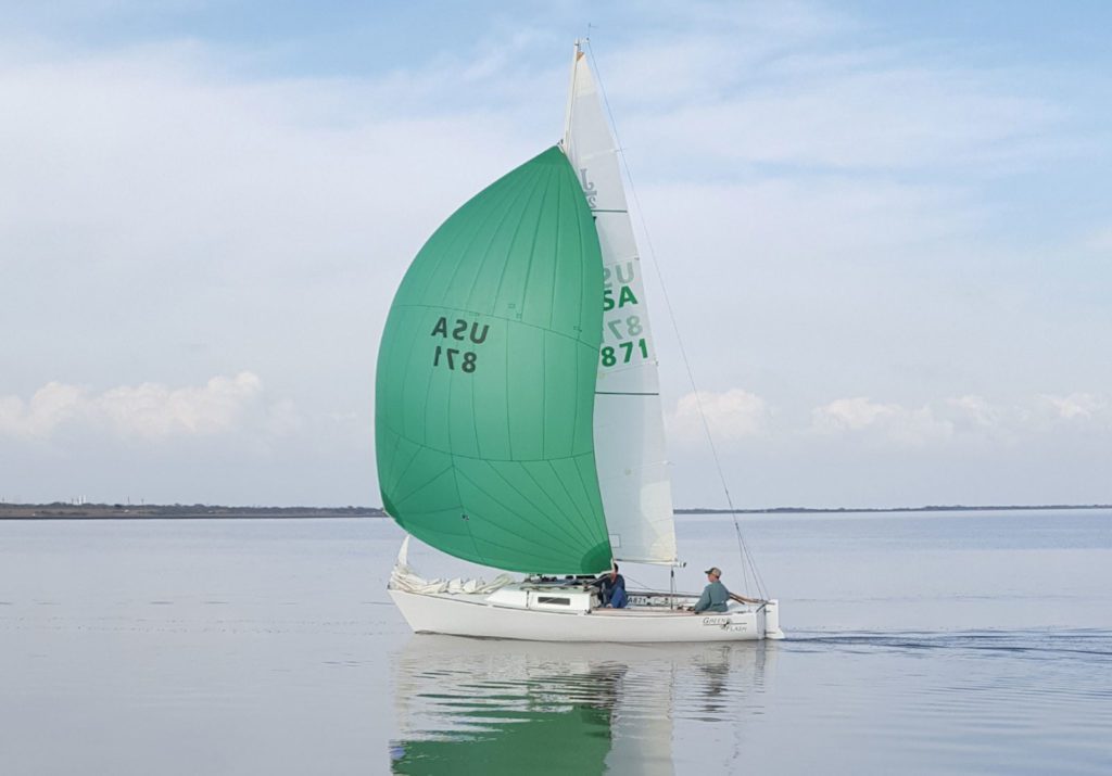 green sailboat on port arthur's sabine lake