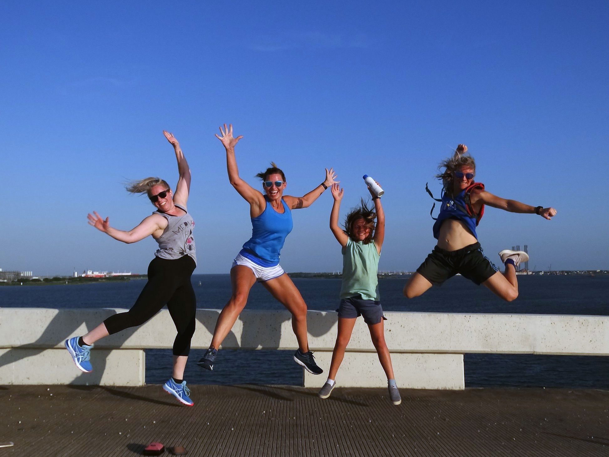 four ladies jumping in the air