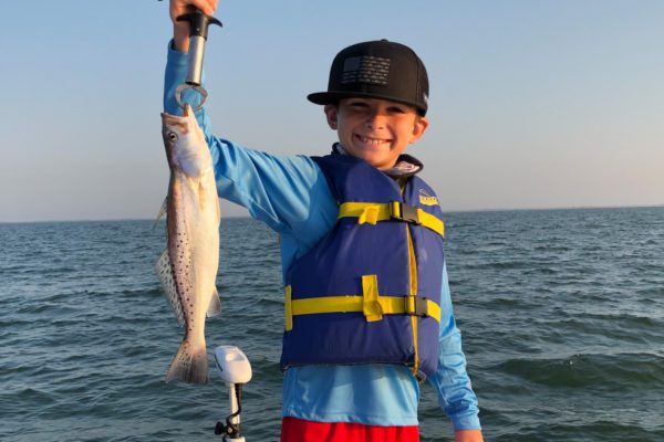 Fishing boy showing off trout in port Arthur, texas