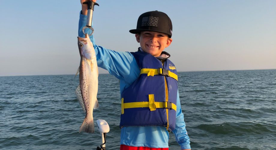 Fishing boy showing off trout in port Arthur, texas