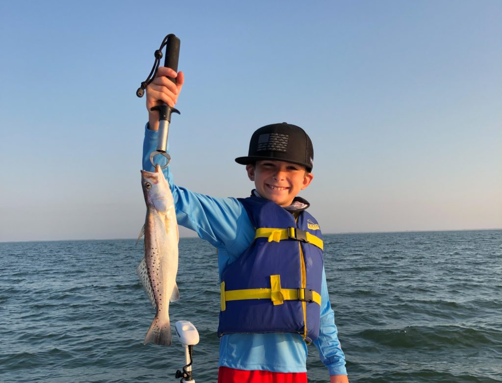 Boy showing off trout in port Arthur texas