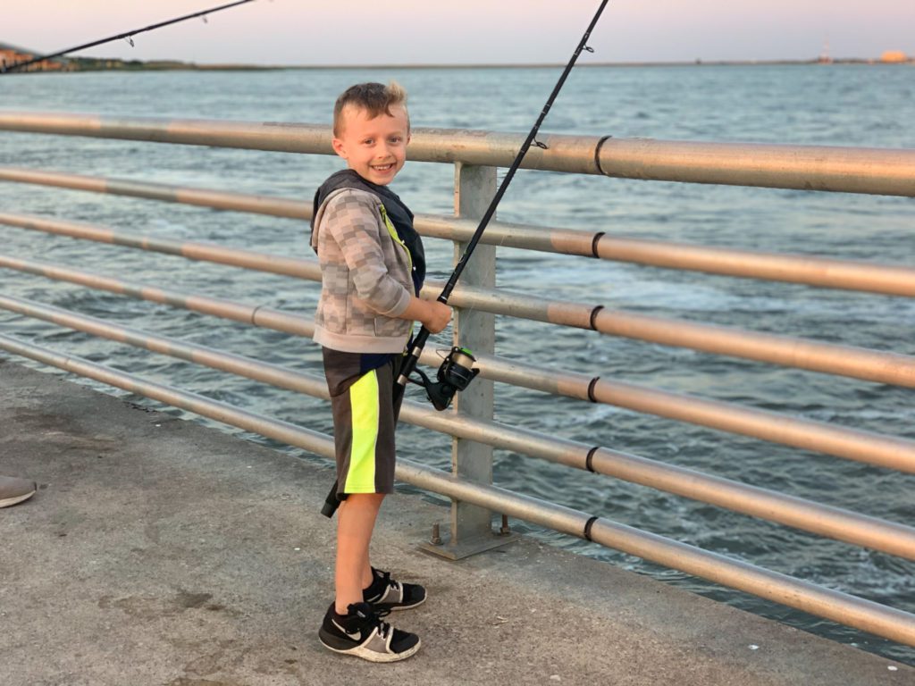 Boy pier fishing in Pleasure Island, Port Arthur