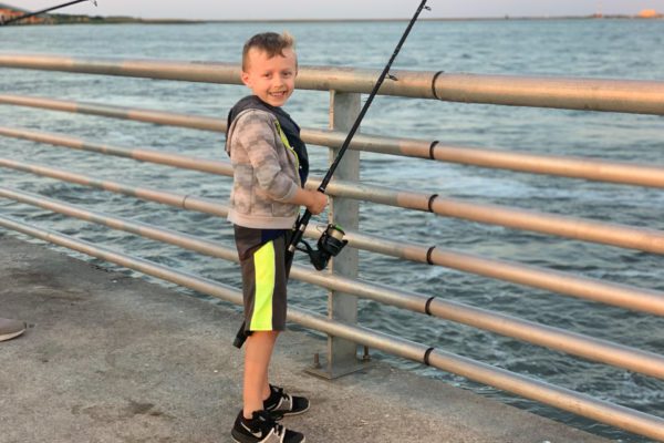 Boy pier fishing in Pleasure Island, Port Arthur