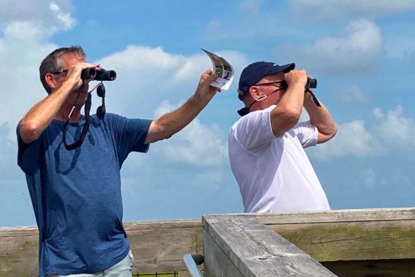 men birding from the boardwalk at sea rim state park