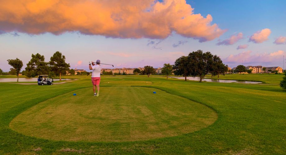 man swinging a club at sunset on the babe zaharias golf course in port arthur texas