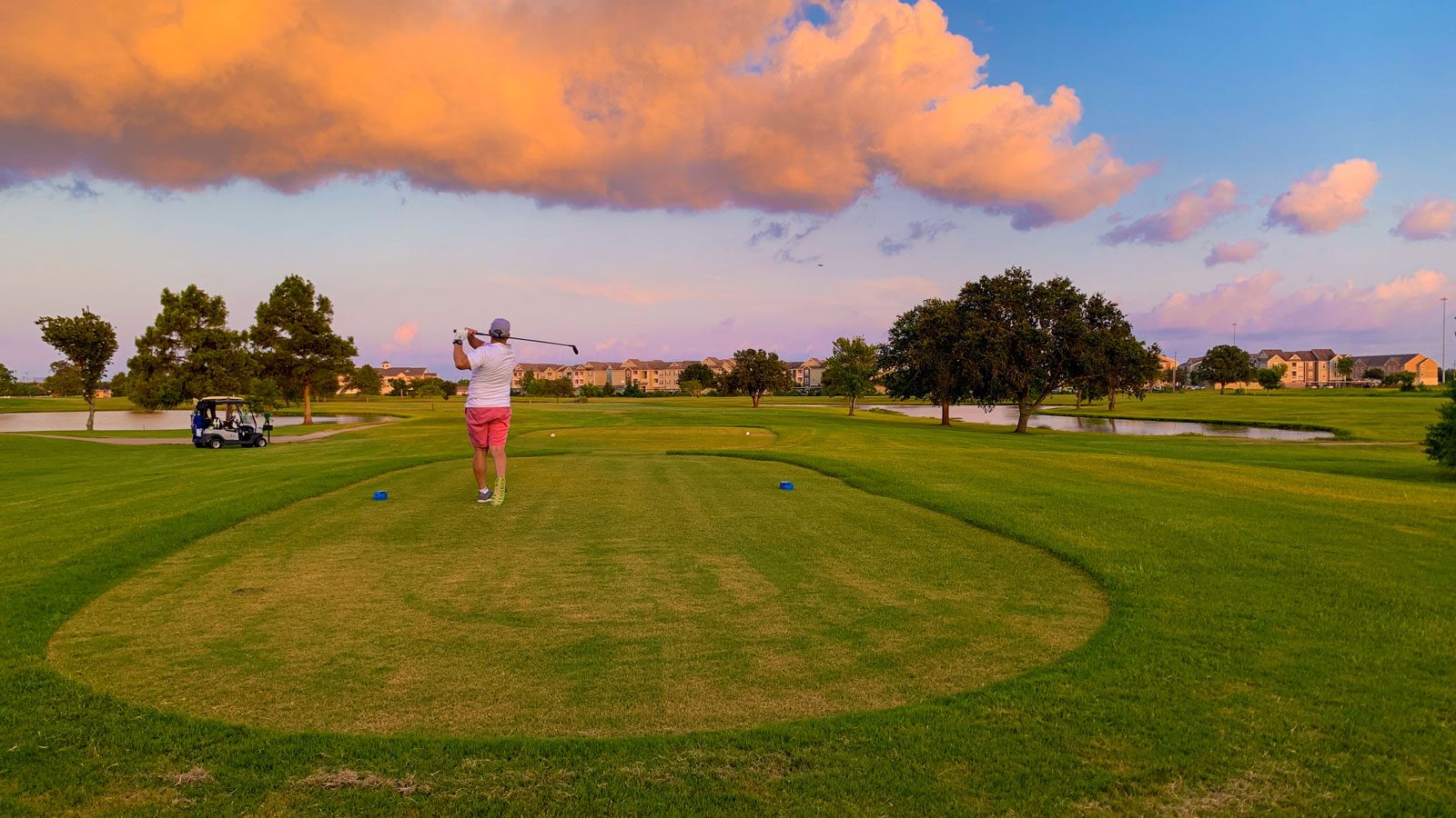 man swinging a club at sunset on the babe zaharias golf course in port arthur texas