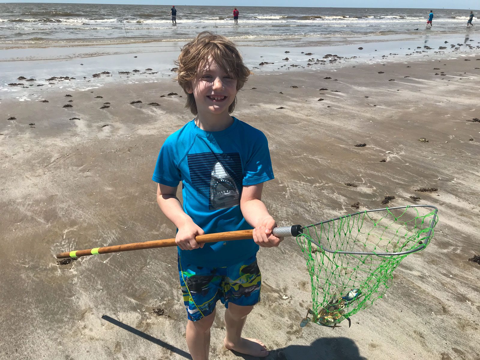 young boy netting a crab at sea rim state park in port arthur, texas