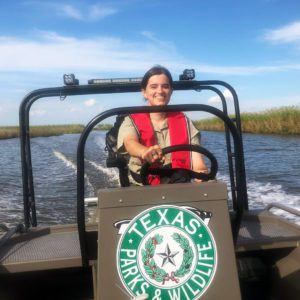 woman driving boat at sea rim state park in port arthur, texas