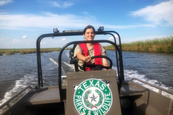 woman driving boat at sea rim state park in port arthur, texas