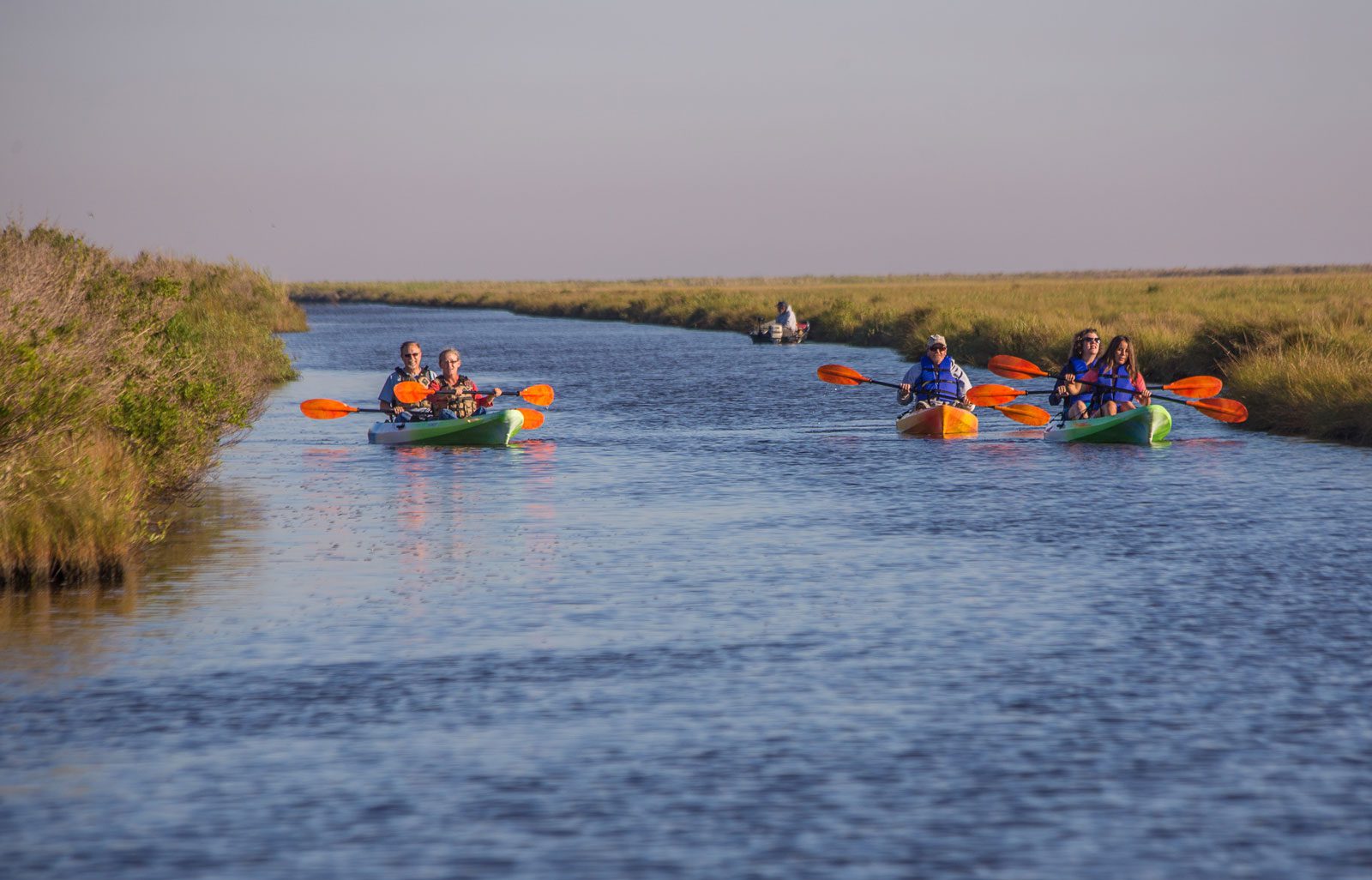 group of kayakers paddling sea rim state park's trails in port arthur texas