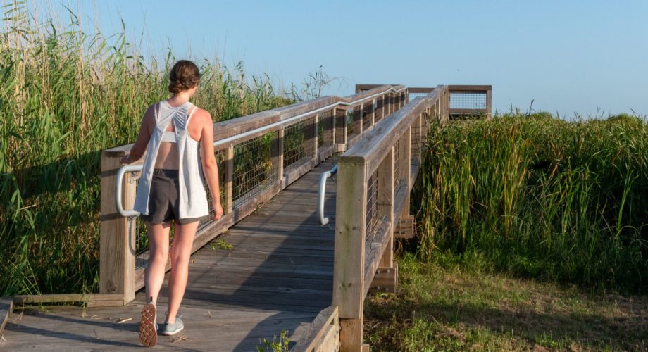 girl walks on boardwalk in port arthur texas