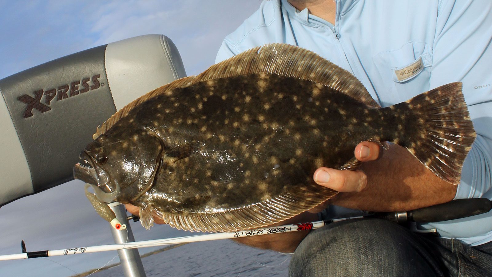 hands holding a flounder in port arthur, texas