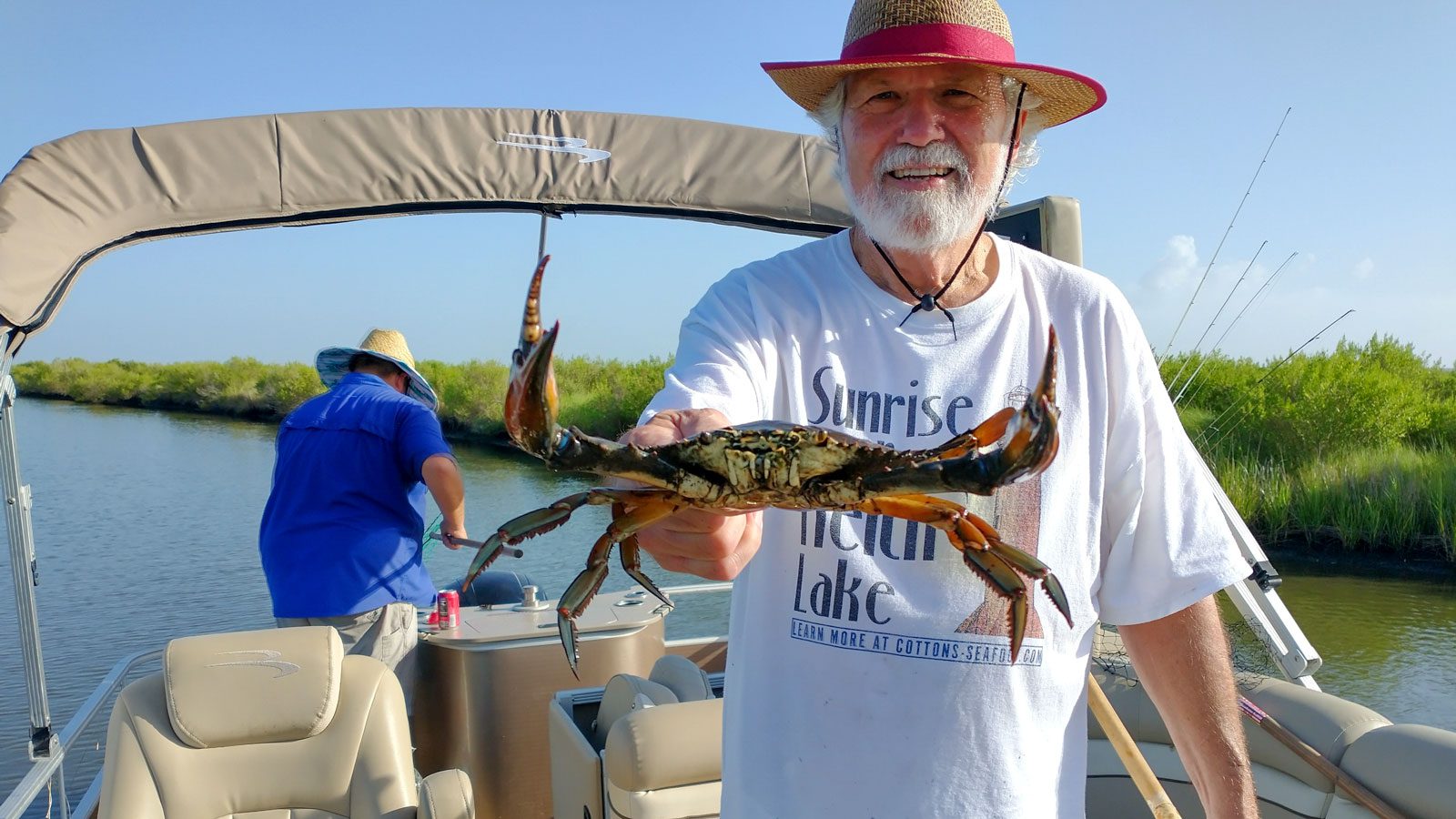 jim labove showing off his crab catch on keith lake in port arthur texas