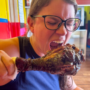 JAWS Bar-B-Que in Port Arthur, TX woman takes a bite of turkey leg