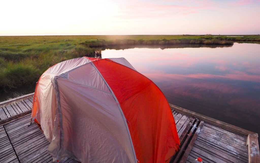 tent on a platform overlooking the marsh unit at sea rim state park