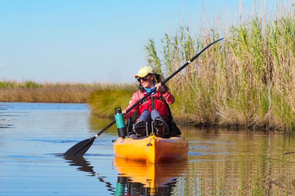 girl paddles in the marsh unit at sea rim state park