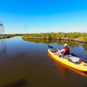 a girl paddles the marsh unit at sea rim state park in port arthur texas