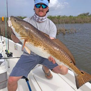 man holds giant redfish caught in sabine lake in port arthur texas