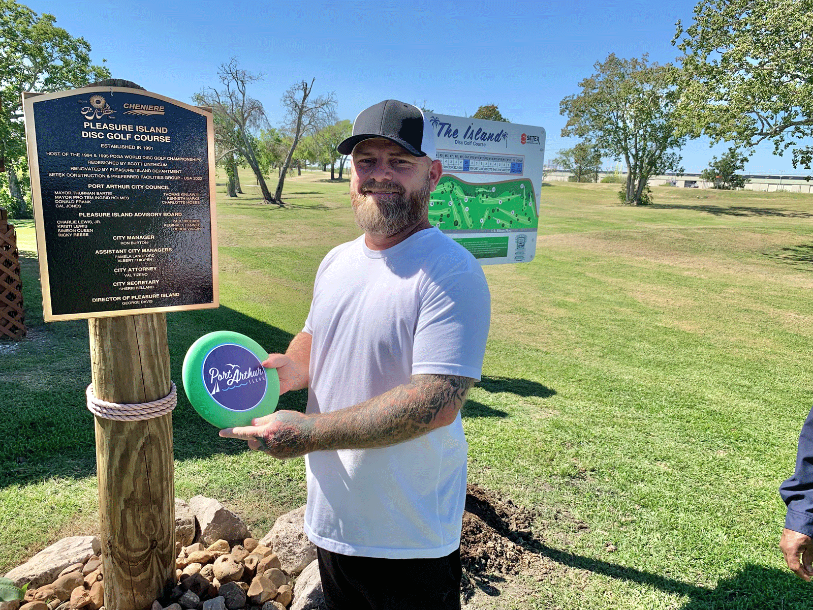 man holds disc at disc golf course on pleasure island in port arthur, texas