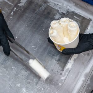 J Baby Ice Cream Rolls & Treats in Port Neches, TX worker stuffs rolled ice cream in bowl