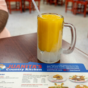Juanitas Country Kitchen in Nederland, TX orange juice frosted mug and menus