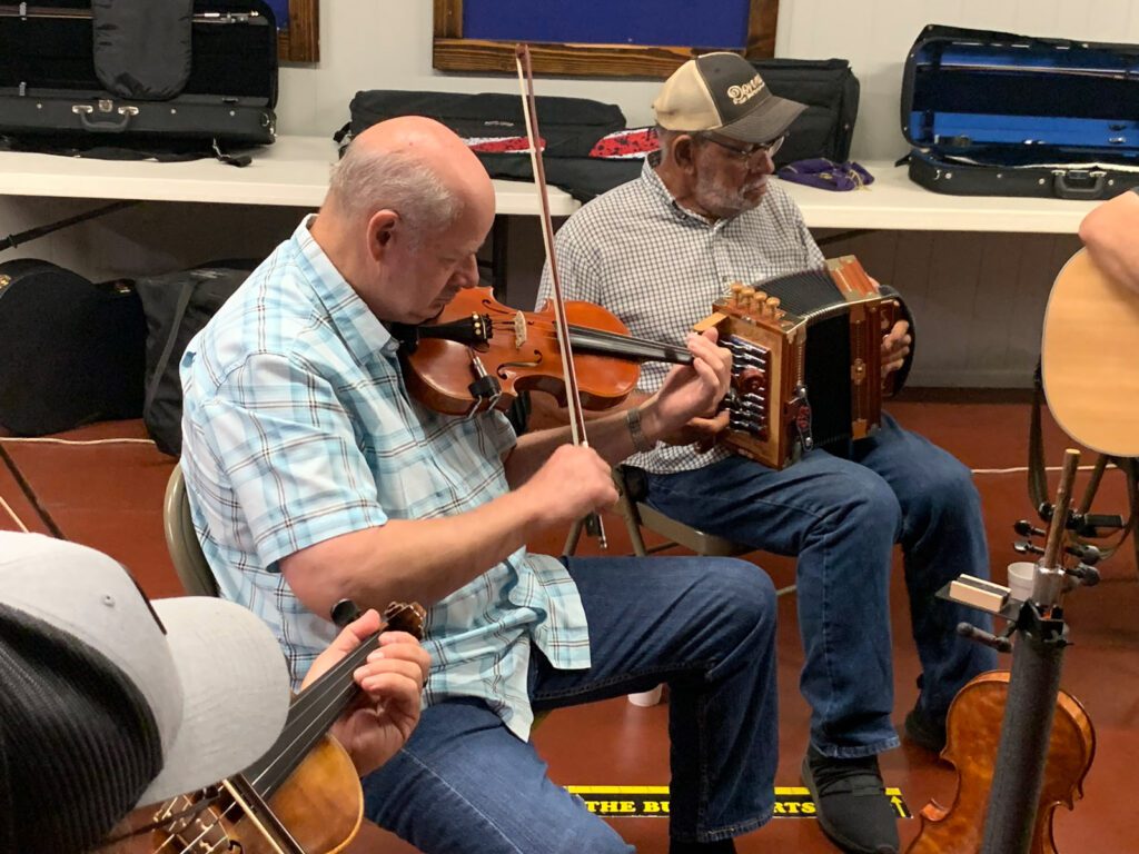 two men playing cajun instruments in port arthur teas