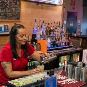 woman mixing a cocktail at pin and tonic in port arthur texas