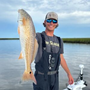 sabine trails guide service captain klate gohlke holding up a redfish on sabine lake in port arthur texas