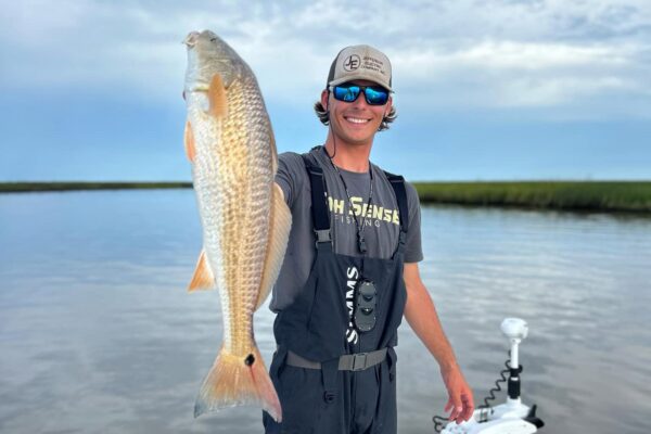 sabine trails guide service captain klate gohlke holding up a redfish on sabine lake in port arthur texas